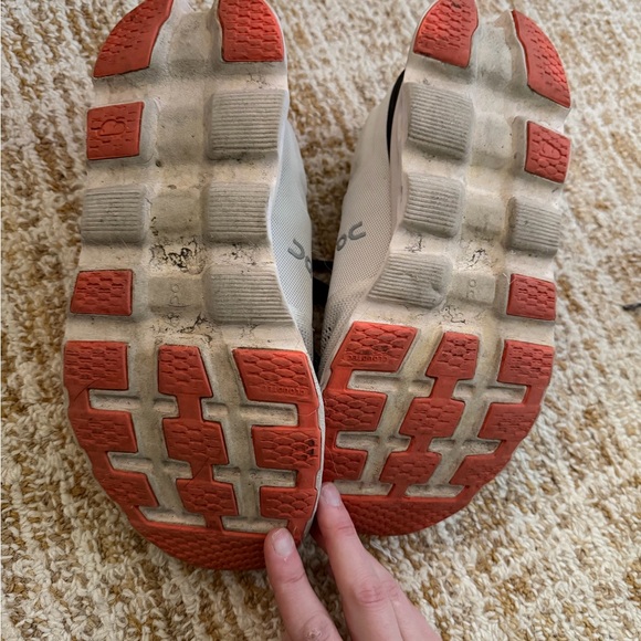 0bfa88d9a1ed6cd587ae97fa1bcbf2  On Running Cream and Black Sneakers with Orange Accents